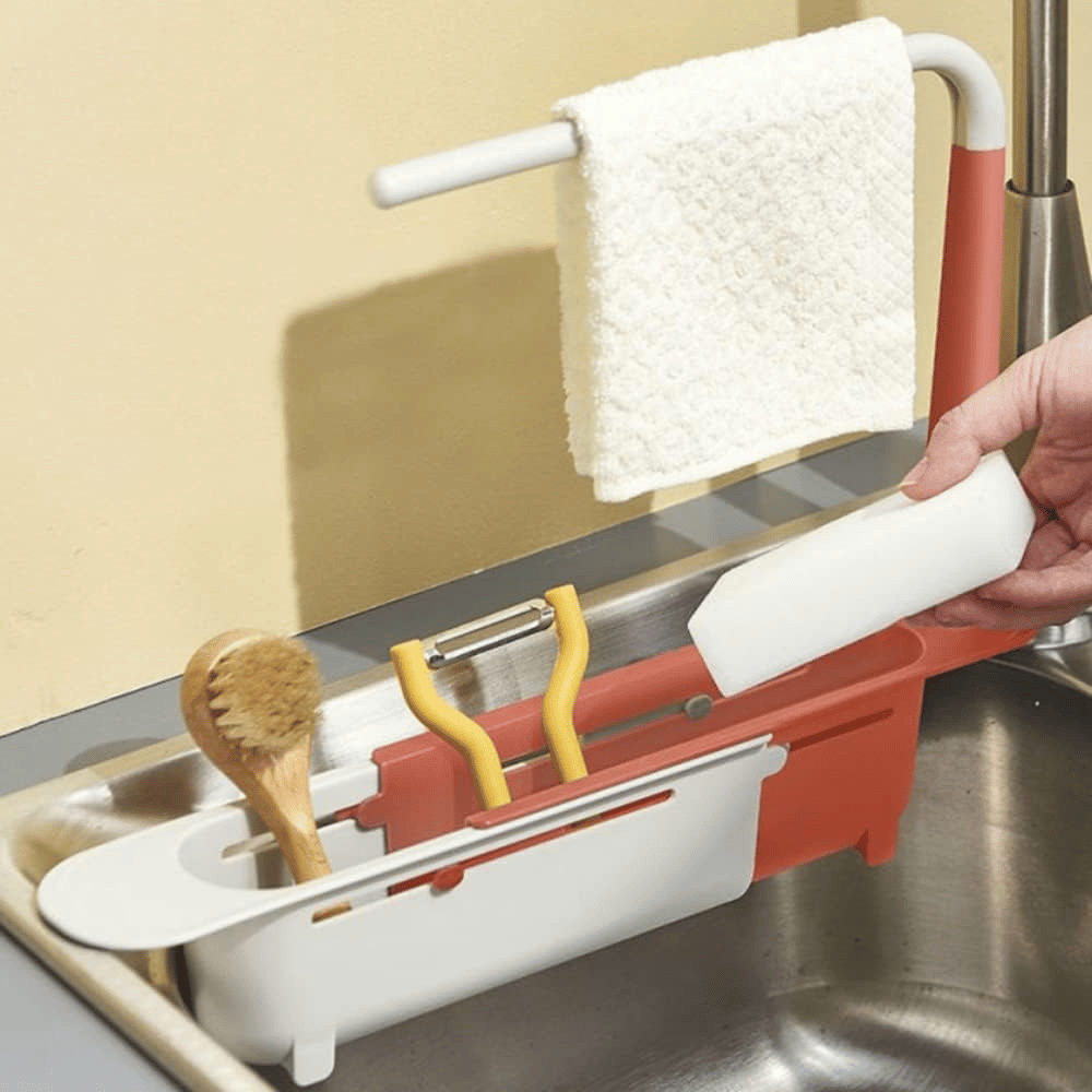 Telescopic sink storage rack holding sponge brushes soap and towel