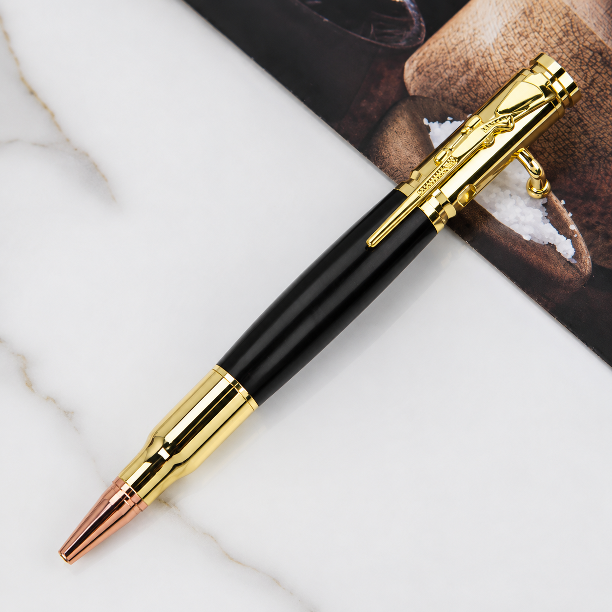 Black and gold bolt action pen with polished metallic hardware