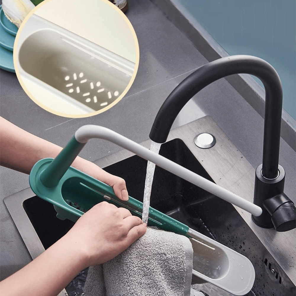 Telescopic sink rack being rinsed showing bottom drainage holes
