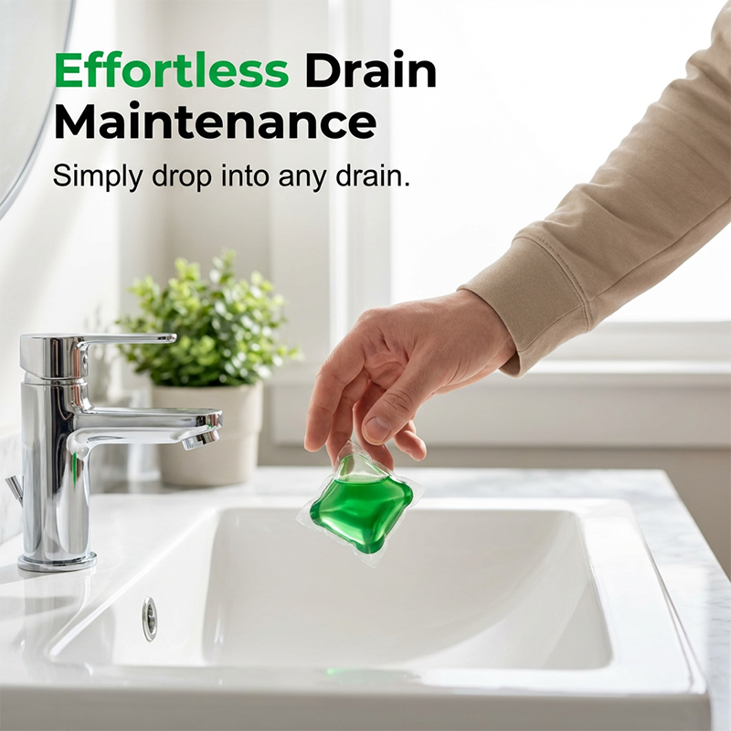 Hand dropping a green deodorizer pod into a bathroom sink drain