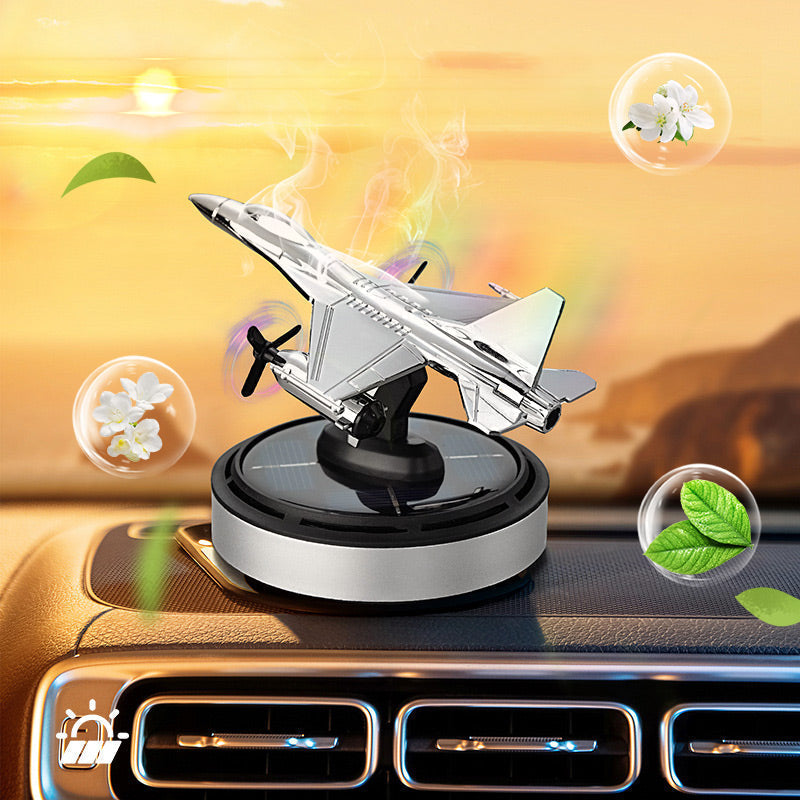 Solar rotating airplane car air freshener on dashboard in sunlight
