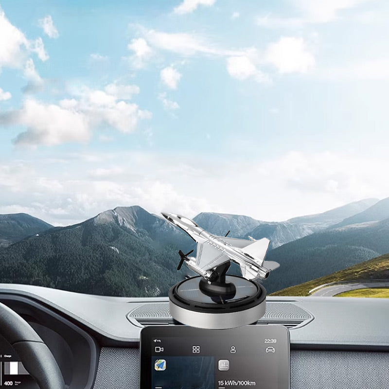Solar airplane ornament positioned on dashboard with clear forward road view